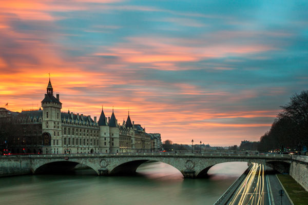 Bridge over river at sunset